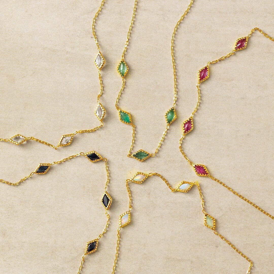 Gold-plated gemstone necklaces with marquise-cut stones in green, black, white and ruby red — elegant semi-precious jewellery from The Gem Bee Jewellery.