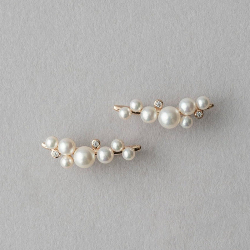 Pair of pearl hairpins on a gray background