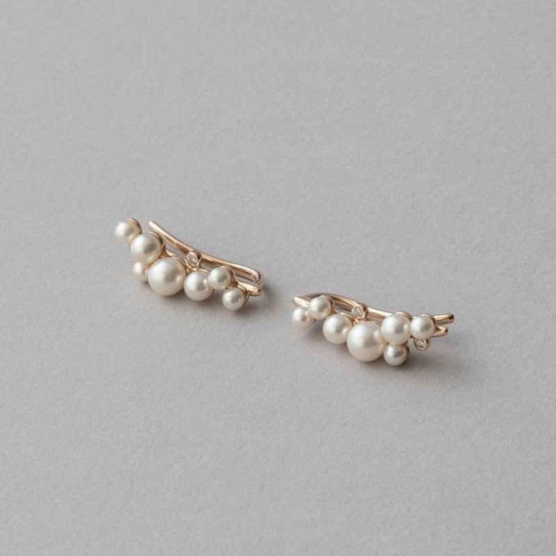Pair of pearl earrings on a gray background
