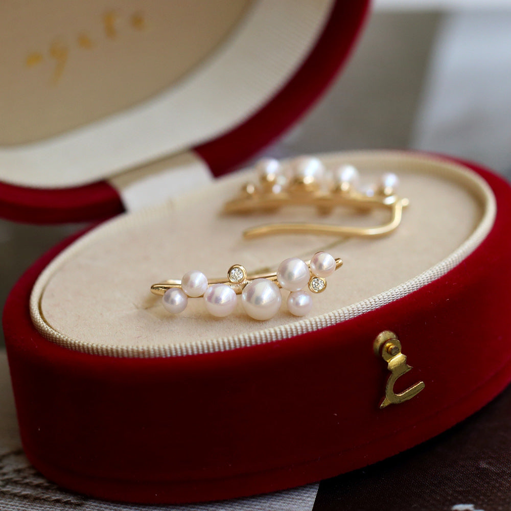 Pearl and gold jewelry set in a red jewelry box