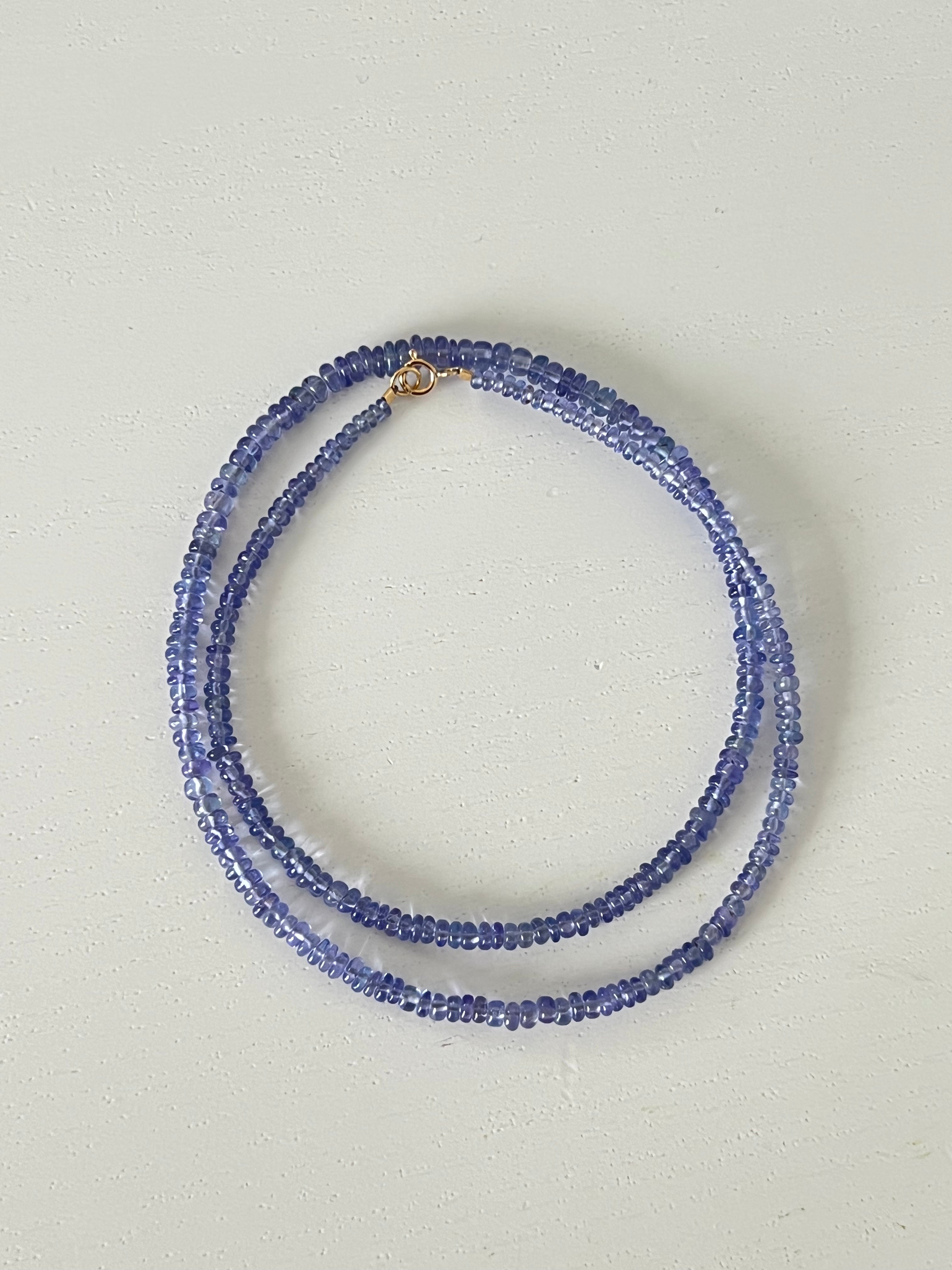 tanzanite beaded necklace on a light gray background