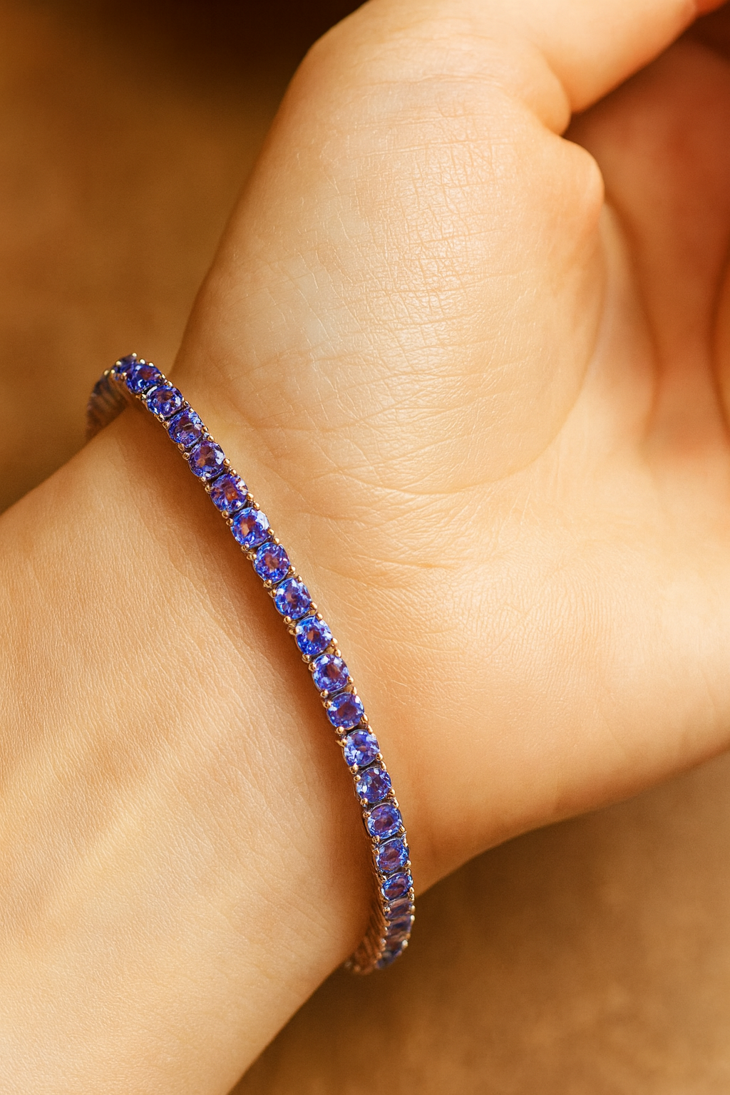 Close-up of a hand wearing a bracelet with purple gemstones.