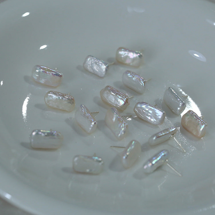 Pearlized earring studs from Gembee Jewellery on a white plate