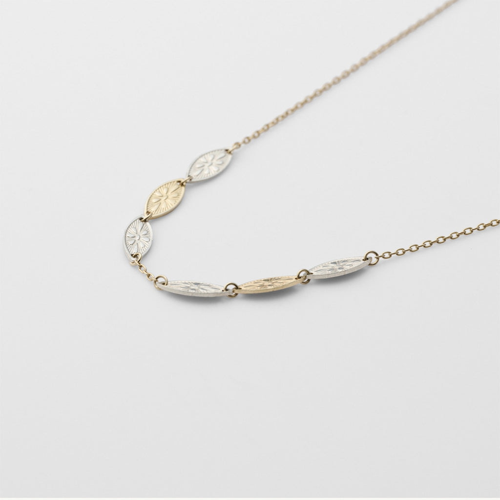 Necklace with leaf-shaped pendants on a light gray background from Gembee Jewellery 
