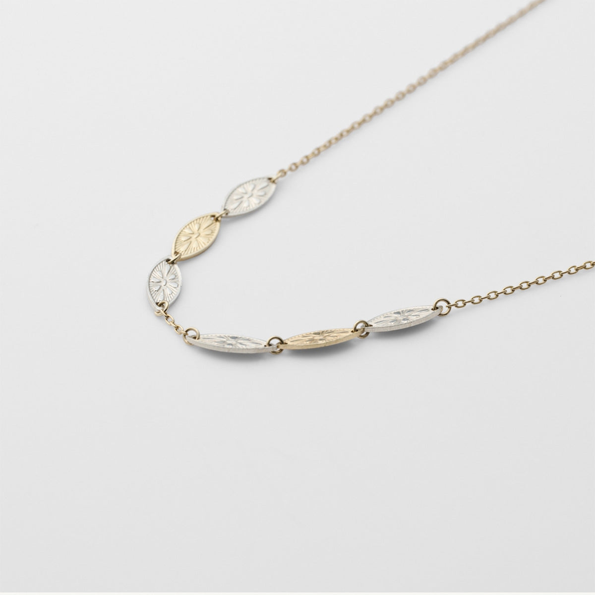Necklace with leaf-shaped pendants on a light gray background from Gembee Jewellery 