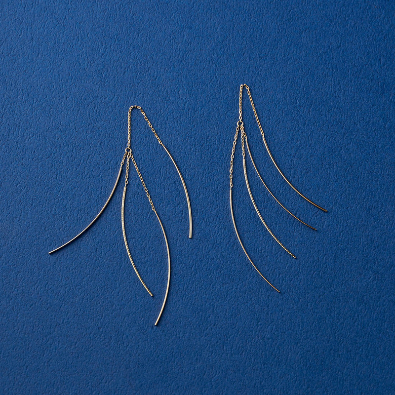 Pair of Comet_Tail_Threader_Earrings on a blue background from Gembee Jewellery