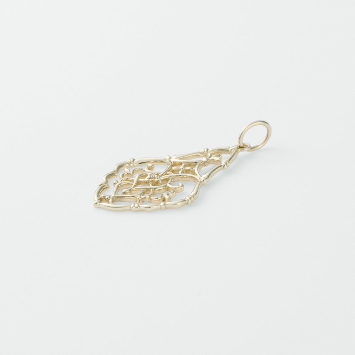 Gold pendant on a light gray background from Gembee Jewellery