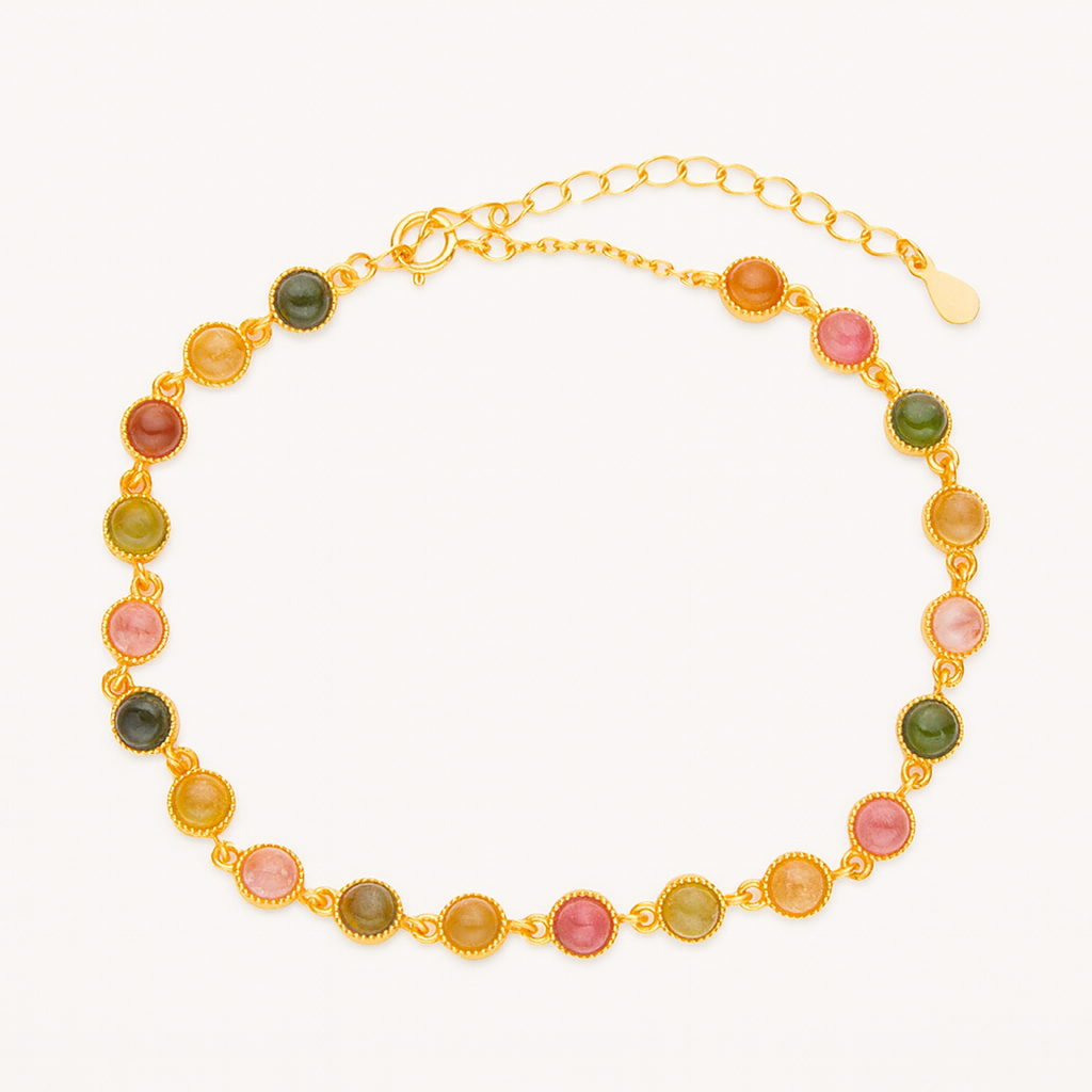 Multicoloured tourmaline bracelet on a gold chain against a white background