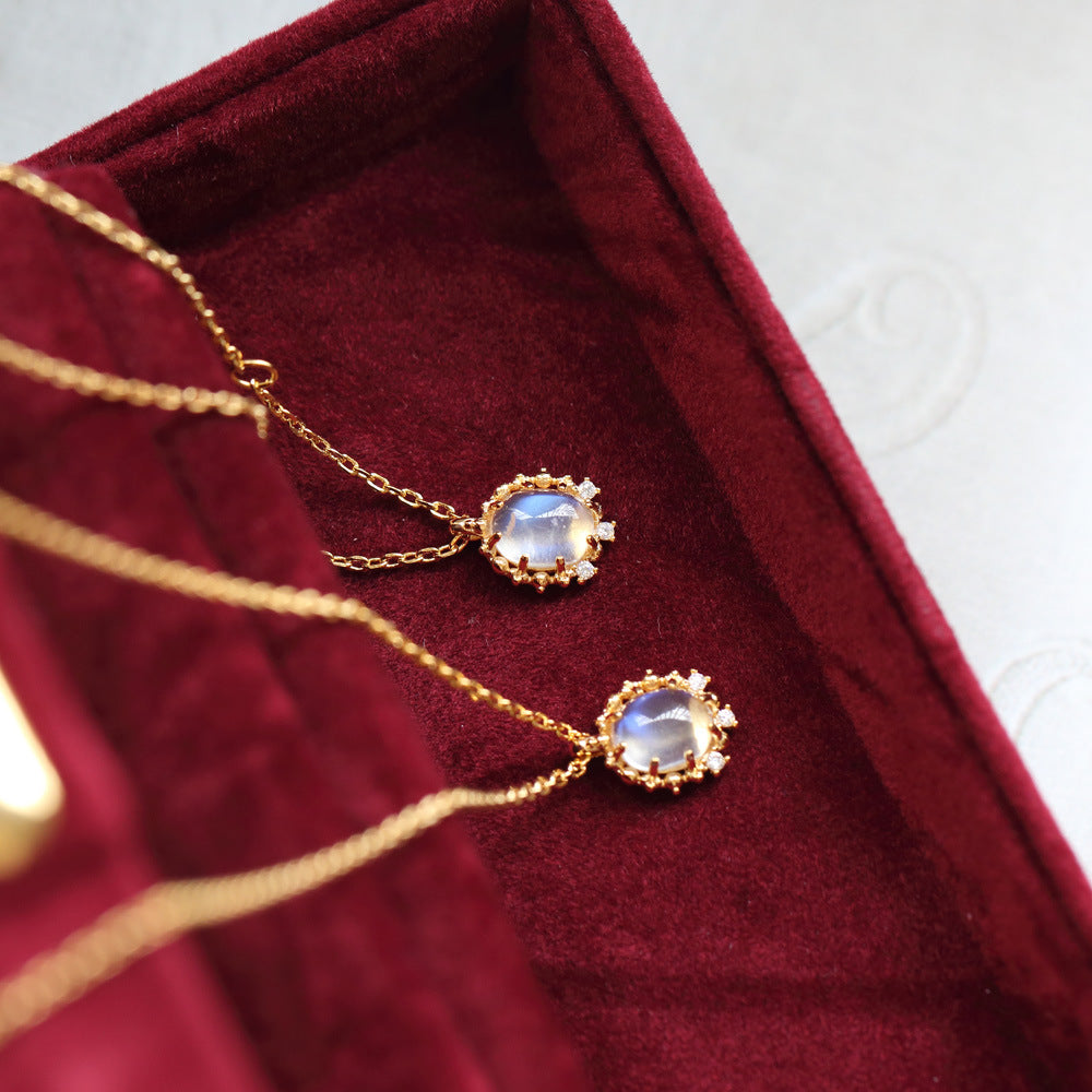 Gold necklaces with gemstones on a red velvet surface